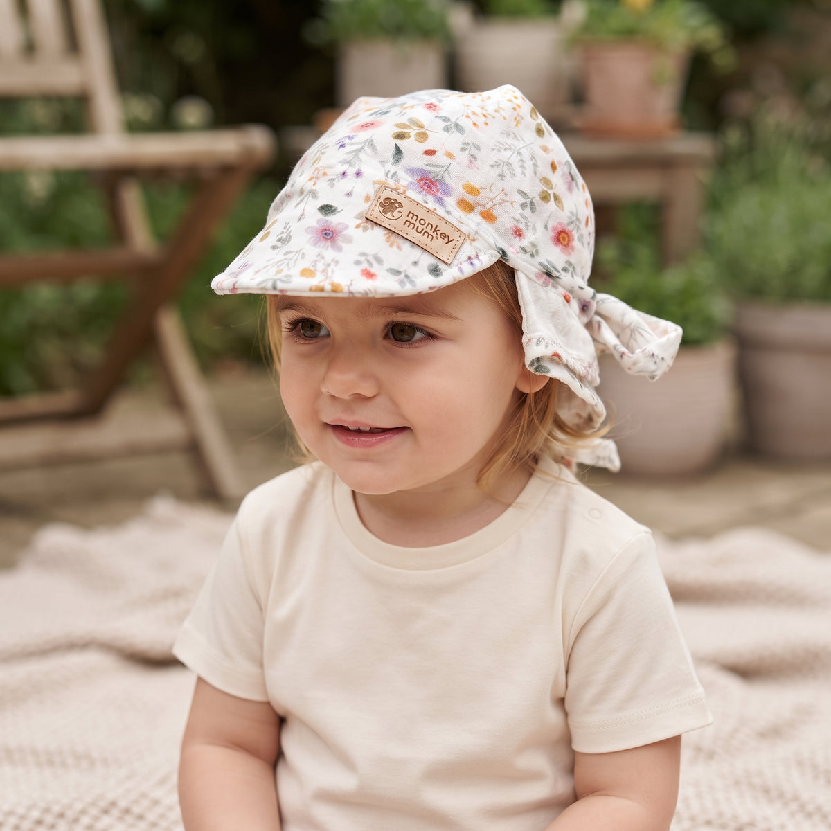 Fascia in mussola con visiera Monkey Mum® - Prato in fiore
